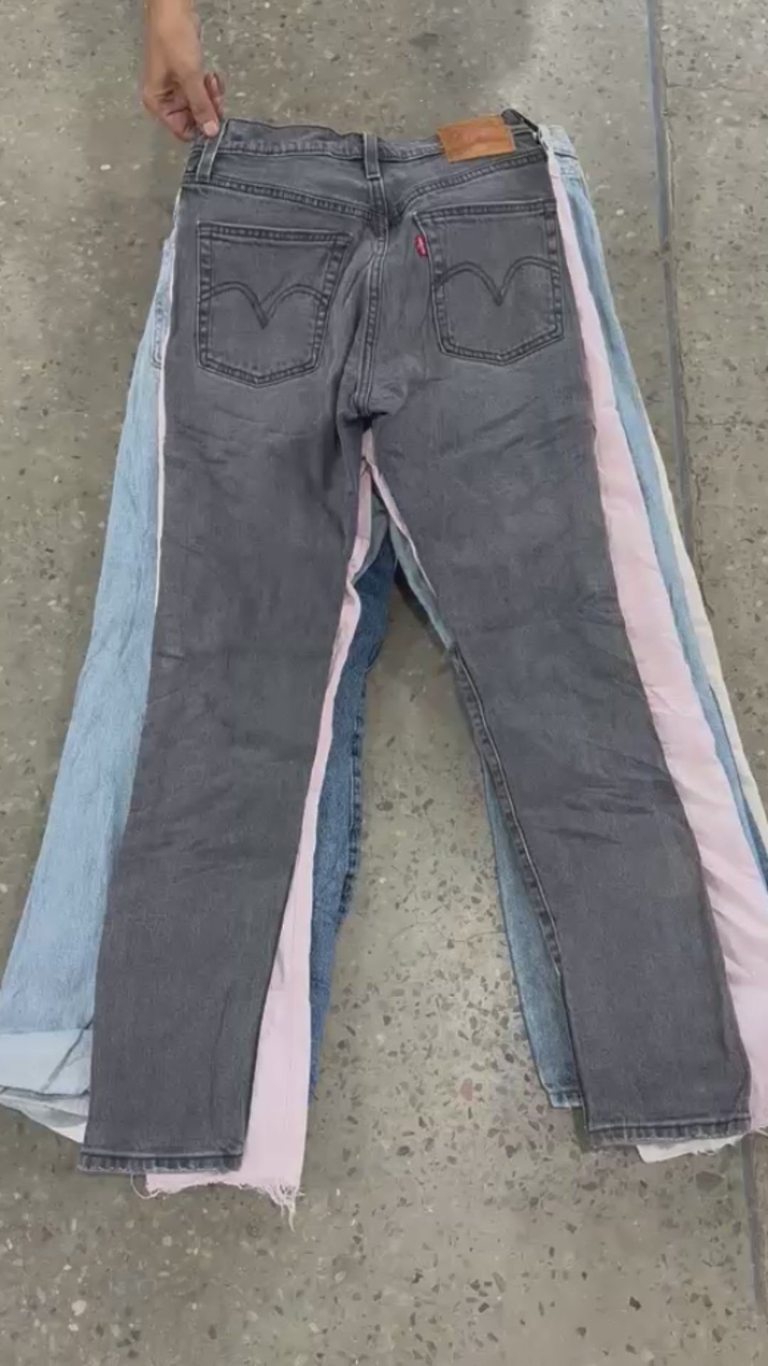 Collection of 501 model levis jeans pulled from a neat stack of jeans in a gallery layout